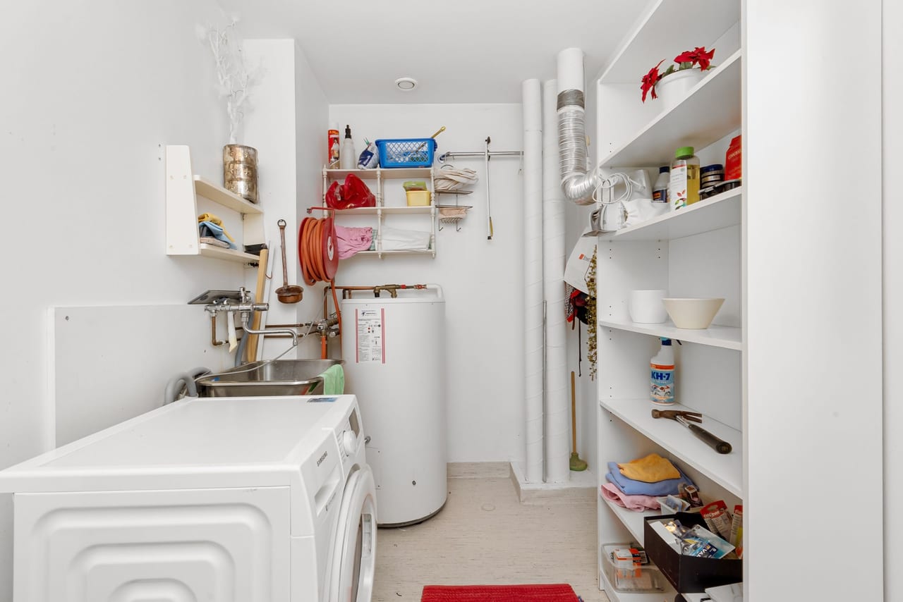 Tank water heater in a residential laundry room